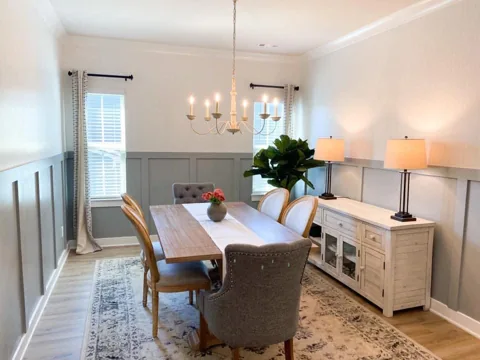 Pale blue-gray lower wall panels wrap a bright dining room.