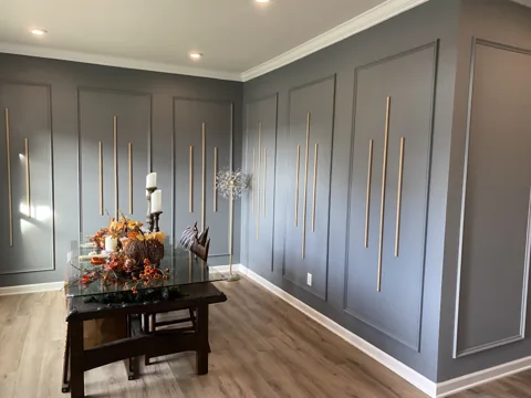 Tall rectangular trim panels bring a repeating pattern to a blue-gray room.