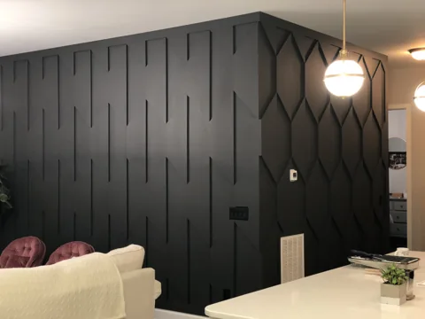 Dark vertical and hexagonal accents meet around a living-room partition.