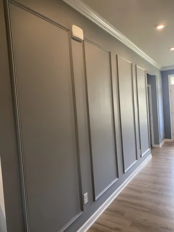 Tall rectangular blue-gray panels line a hallway.